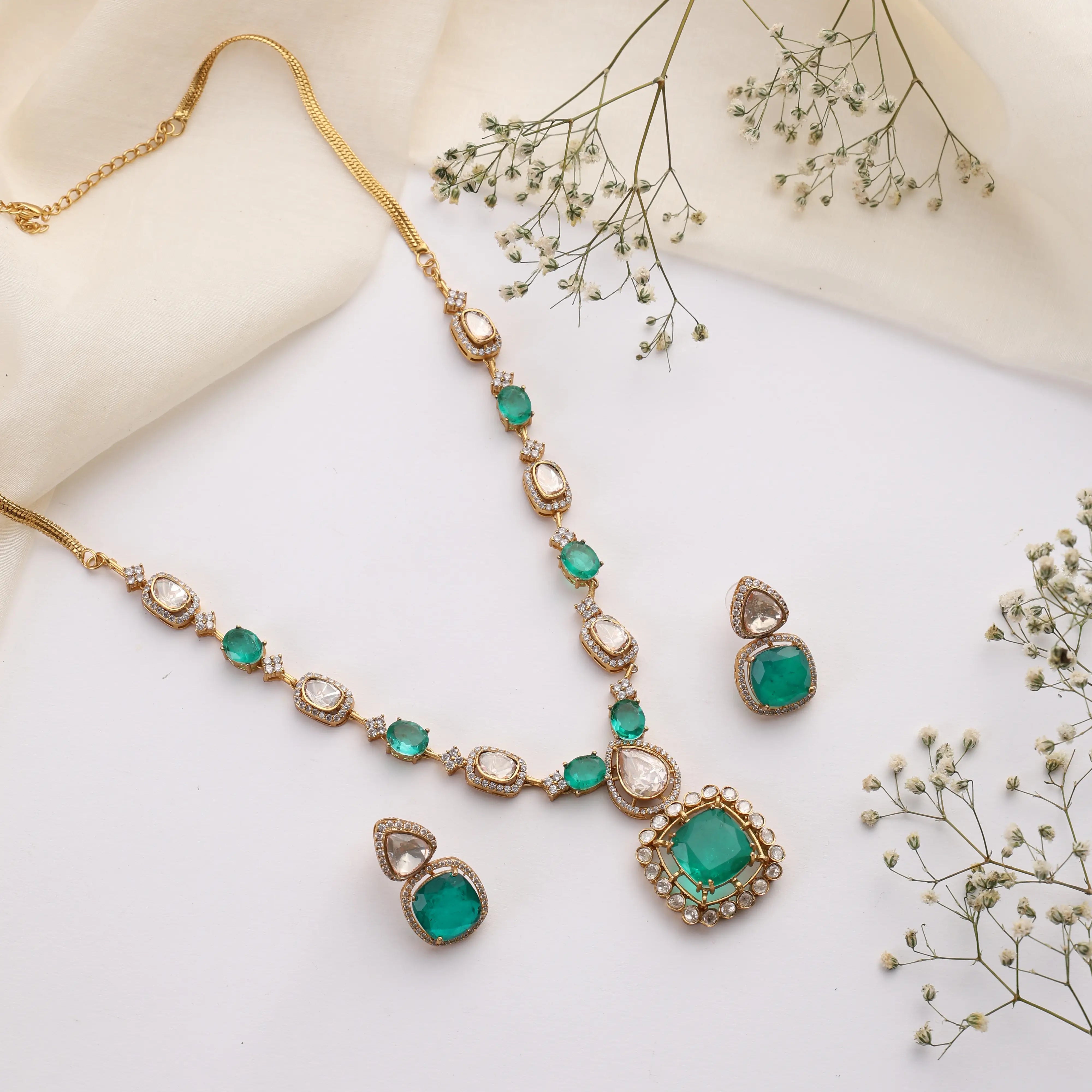 Emerald and polki necklace set with square pendant on white background