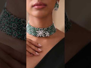 Close-up of emerald stone choker with floral CZ detailing on model