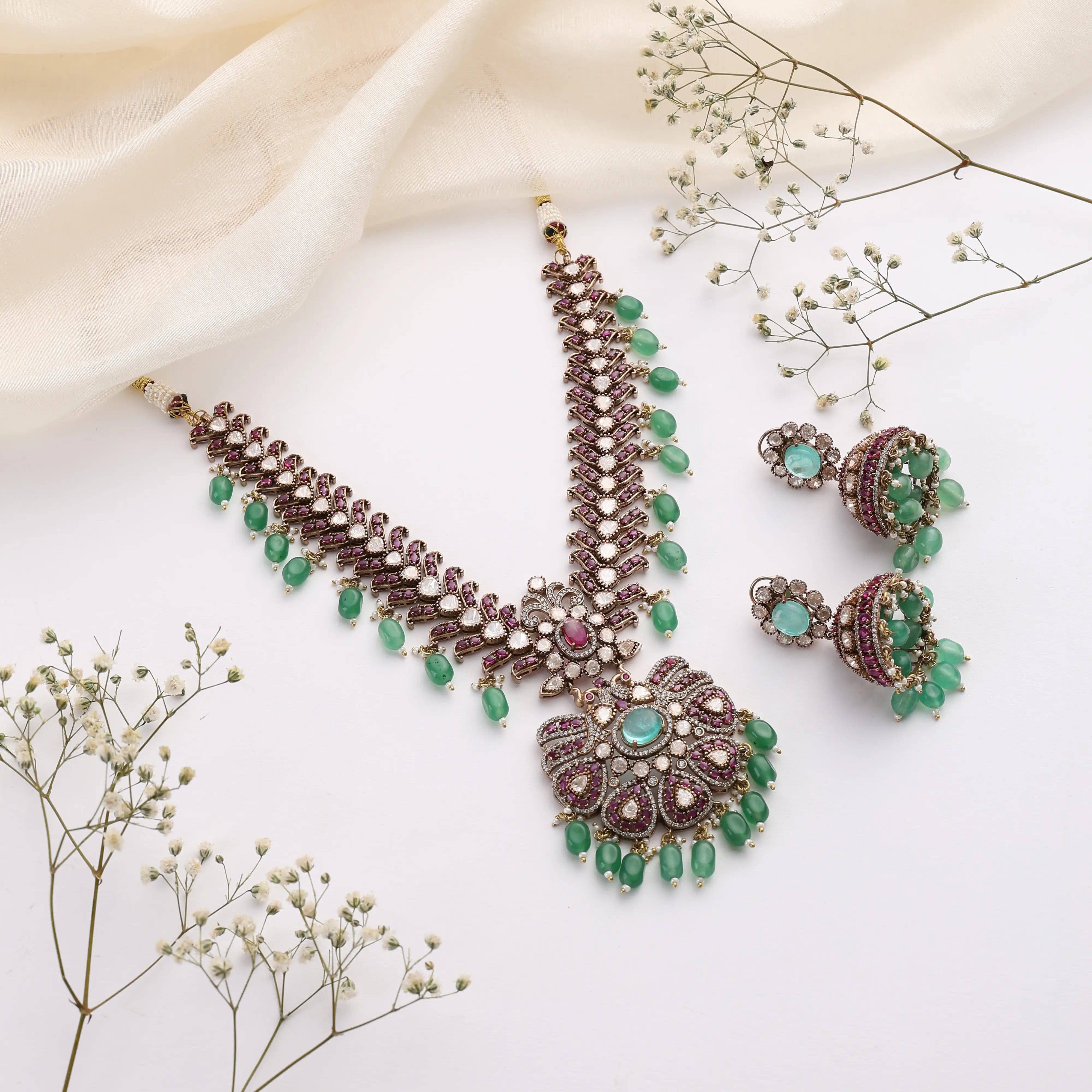 Regal Emerald Ruby Kundan Necklace with Jhumka Earrings in Antique Gold Finish