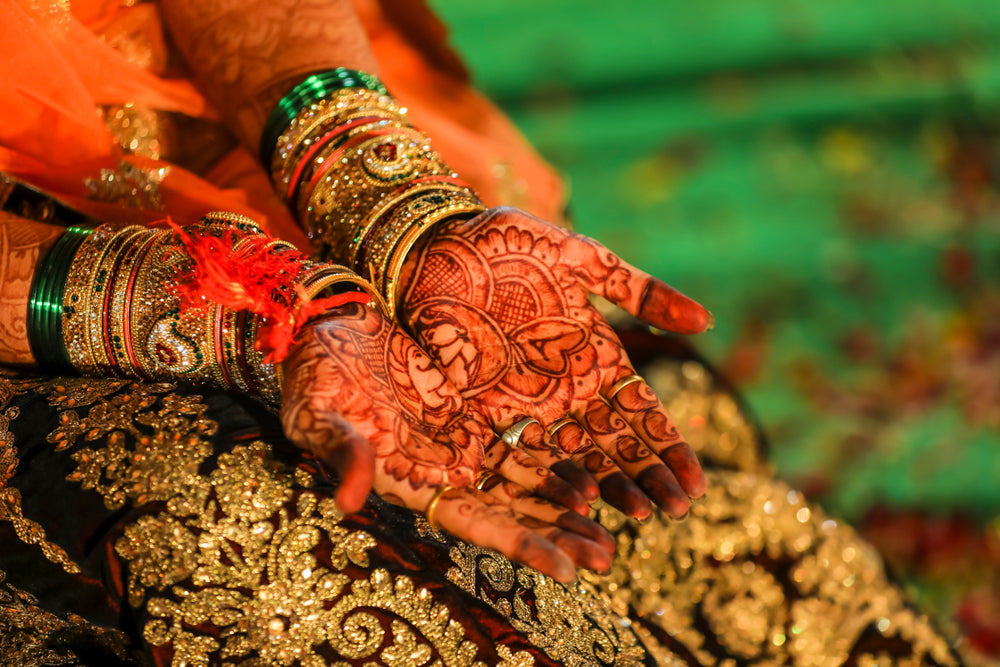 Bride Wearing Jewelry During Mehendi Ceremony