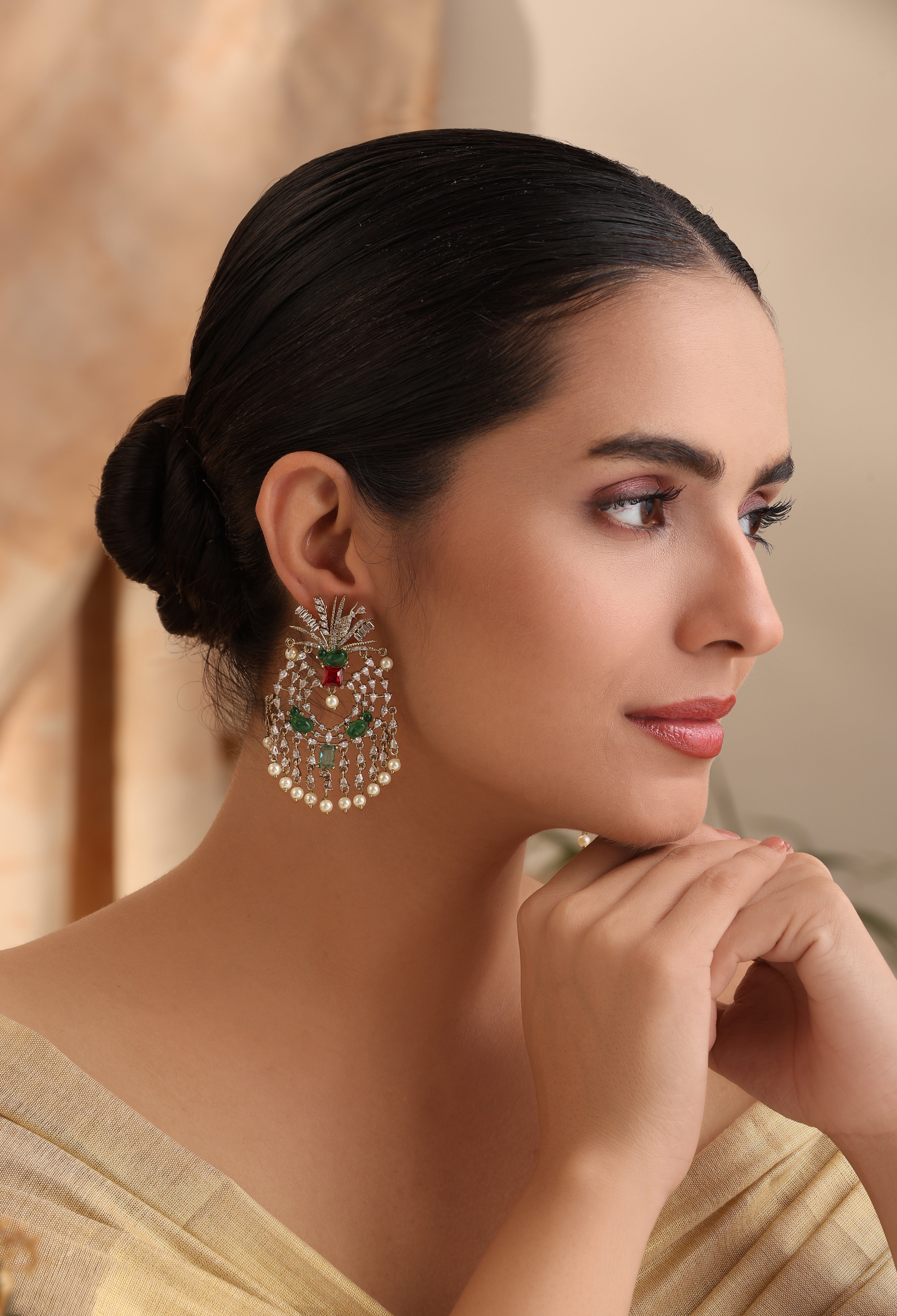 Side profile of Elara Emerald Pearl Chandelier Earrings showing cascading pearls and green stone accents – MyRivaaz.