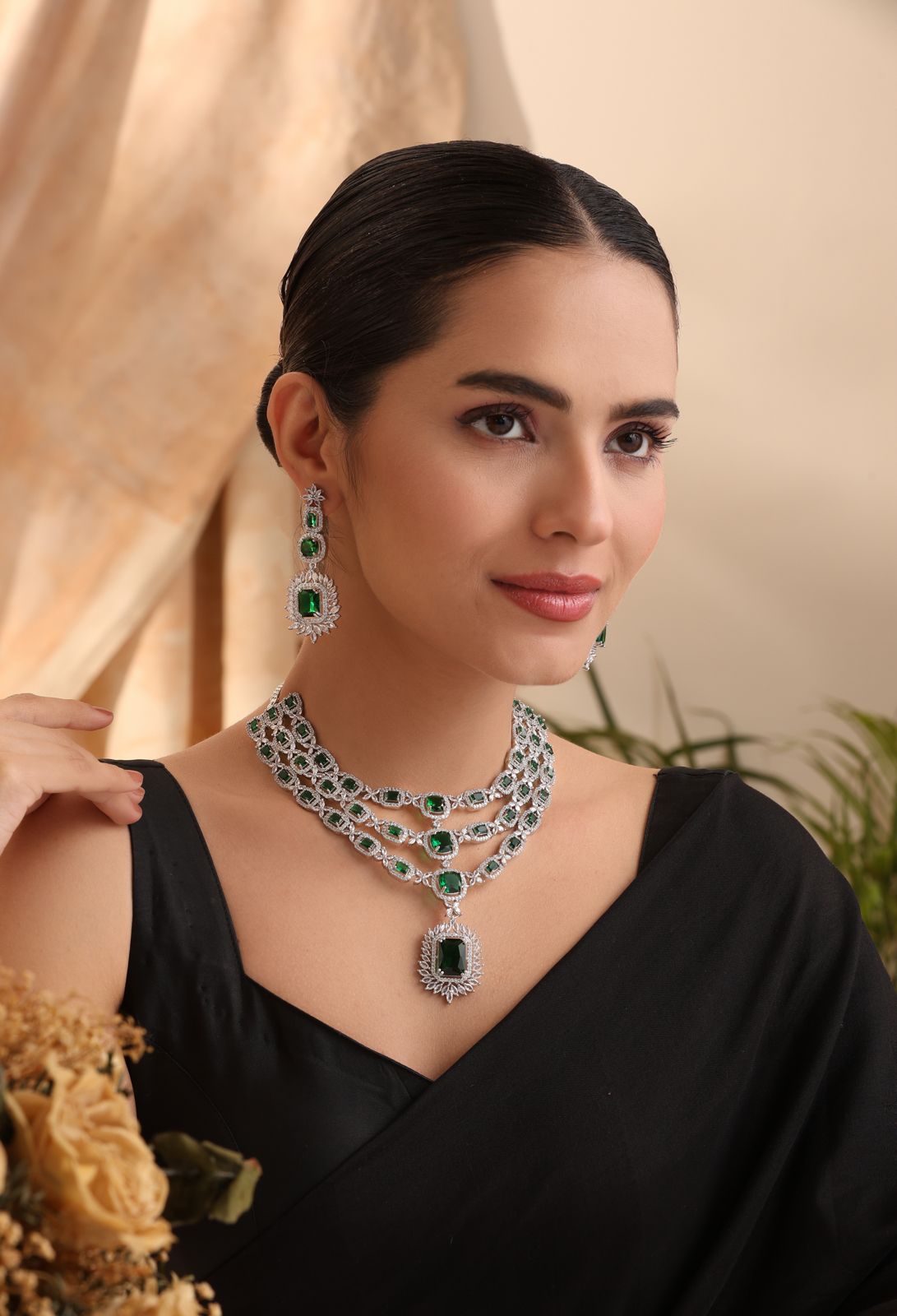 emerald-grace-model-front — “Emerald Grace triple-layer emerald CZ necklace with matching earrings on model, silver finish.”