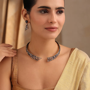 Model wearing sapphire-tone gold choker with matching earrings