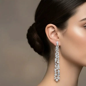 Close-up of a woman wearing a sparkling earring against a neutral background
