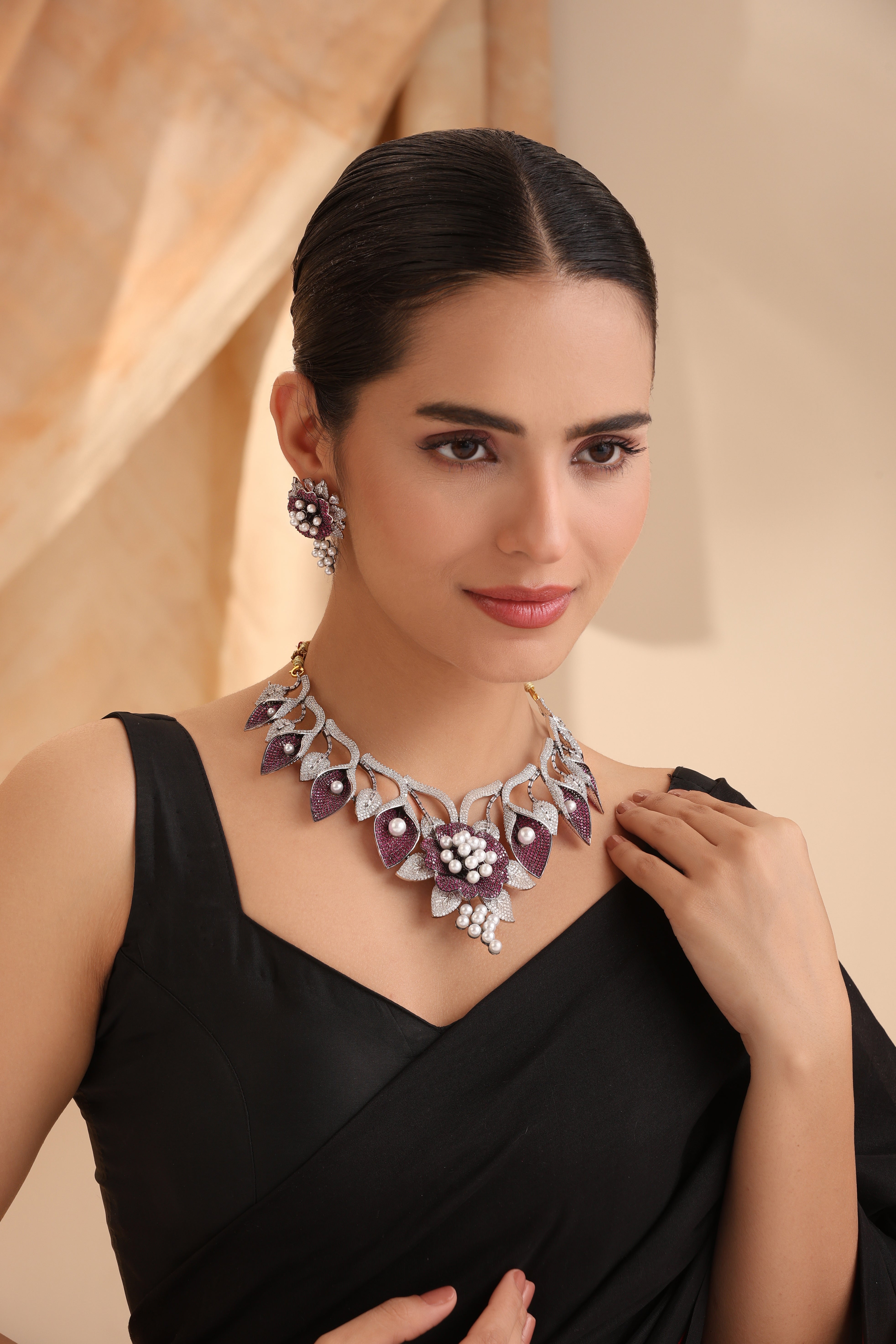 Close-up of Imperial Amethyst Pearl Blossom Necklace Set featuring pave CZ leaves, amethyst stones, and pearl accents in a luxury floral design