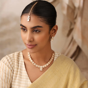 Close-up of Naina uncut polki minimal bridal necklace on model