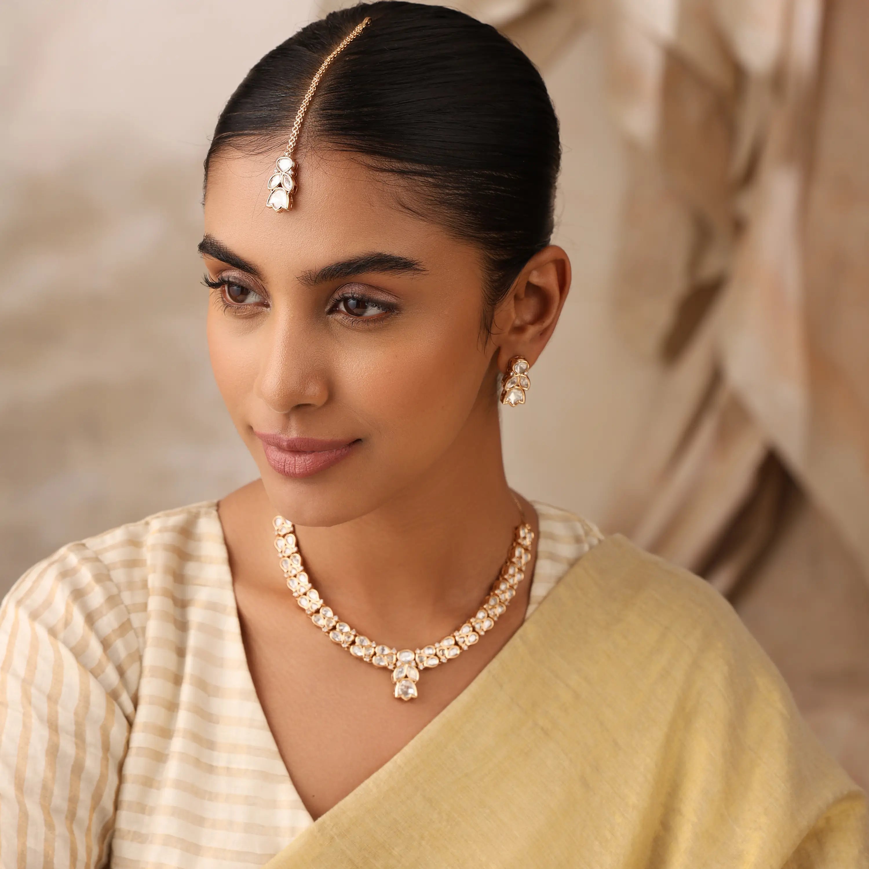 Close-up of Naina uncut polki minimal bridal necklace on model