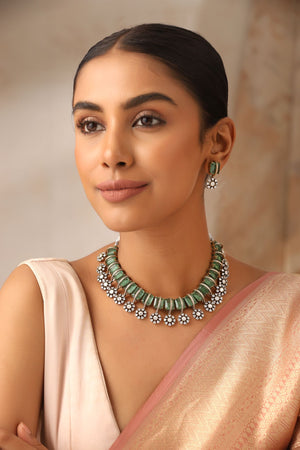 Model wearing Kriti Mint kundan choker with mint doublet stones and matching earrings in Victorian finish