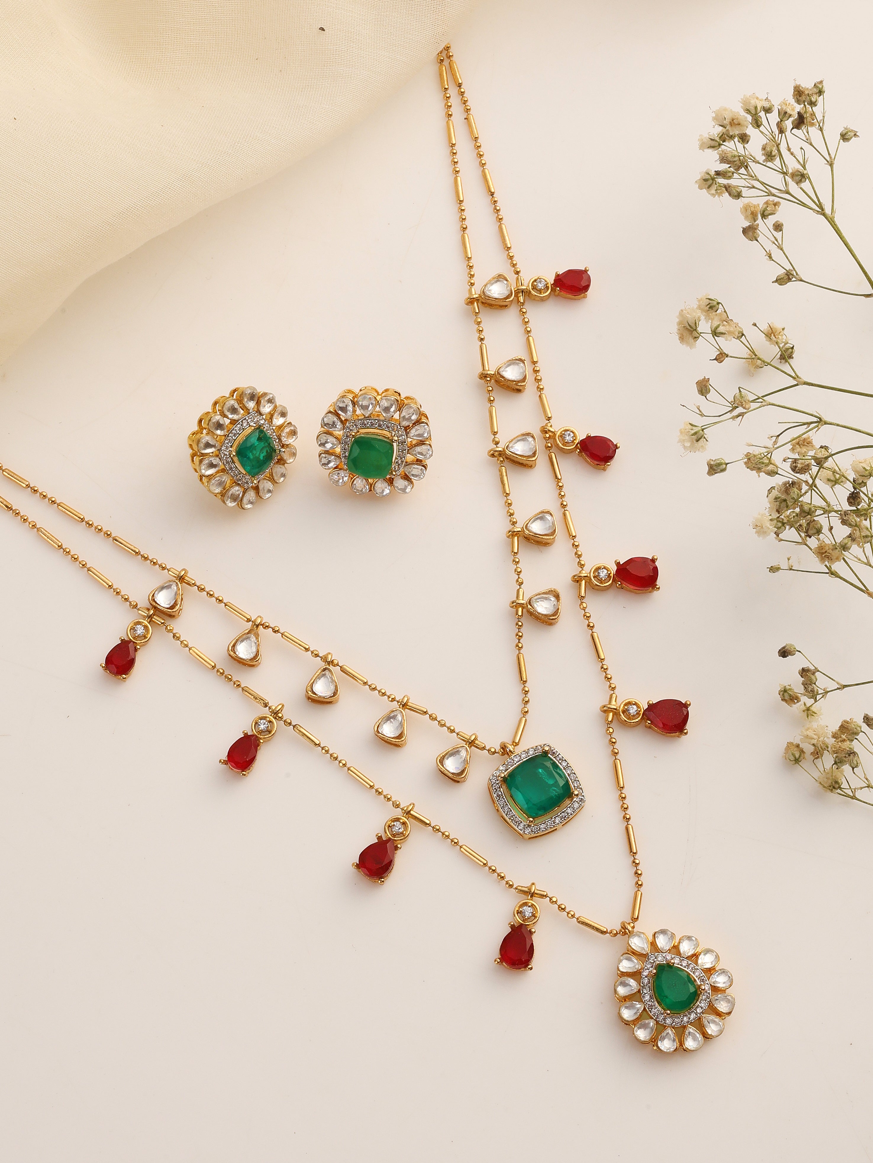 Flatlay of Emerald & Ruby Layered Kundan Necklace Set with Earrings