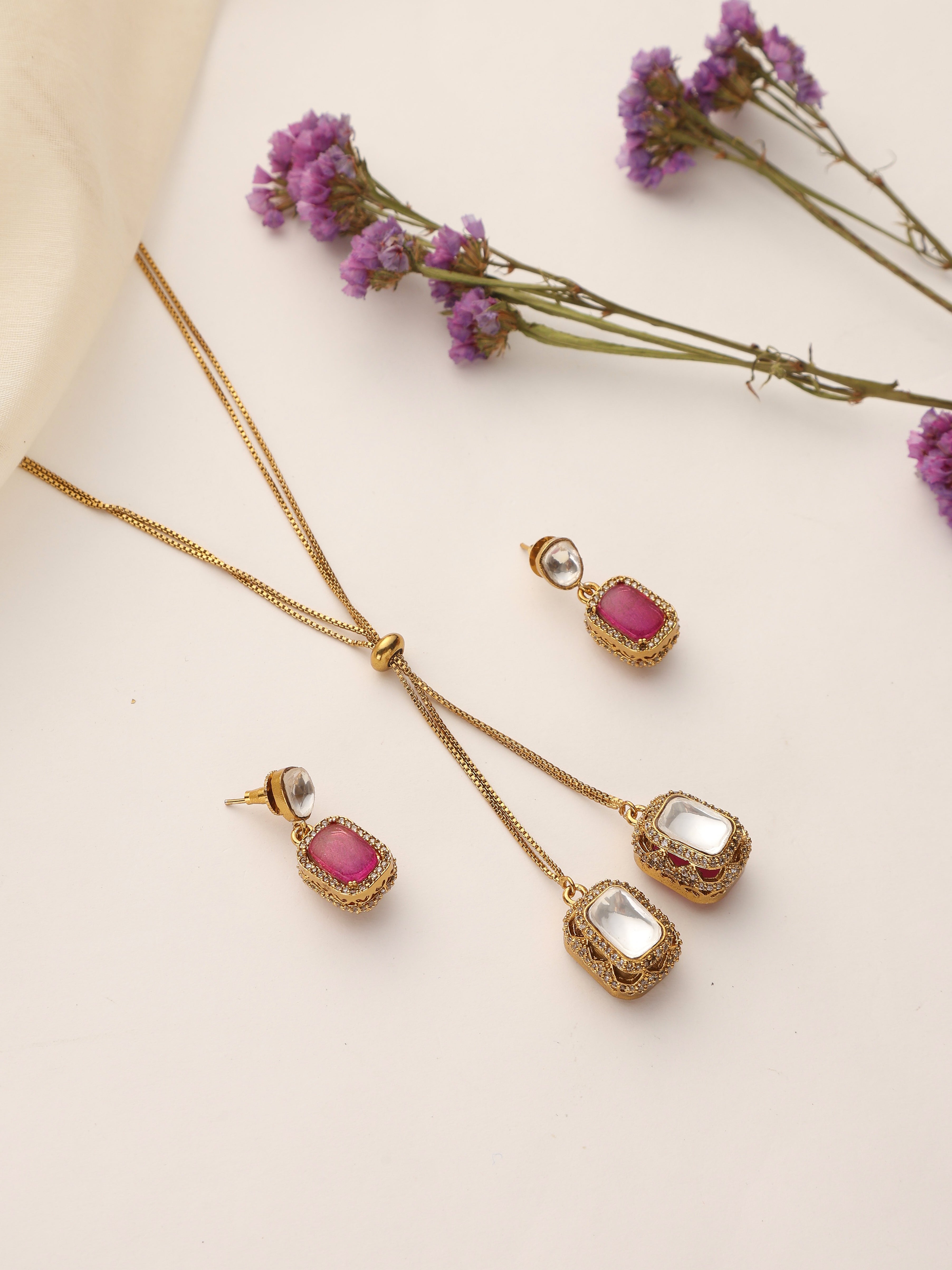 Flatlay of Dual Stone Ruby & Polki Pendant Set with Earrings – Gold Plated