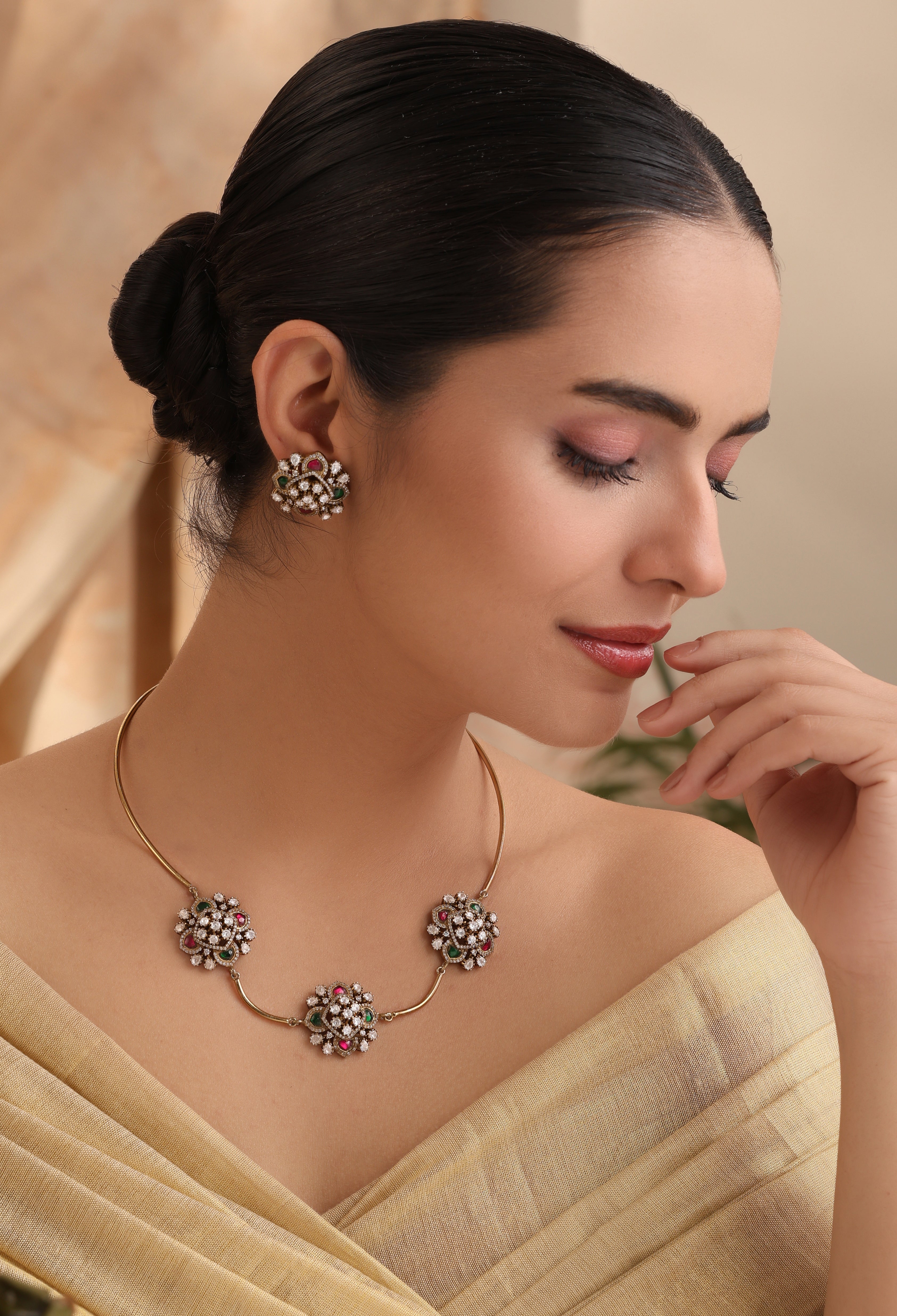 Close-up of Zahra Rosette Moissanite Hasli Set showing rosette motifs on gold-tone hasli choker with emerald & ruby kundan stones – MyRivaaz.