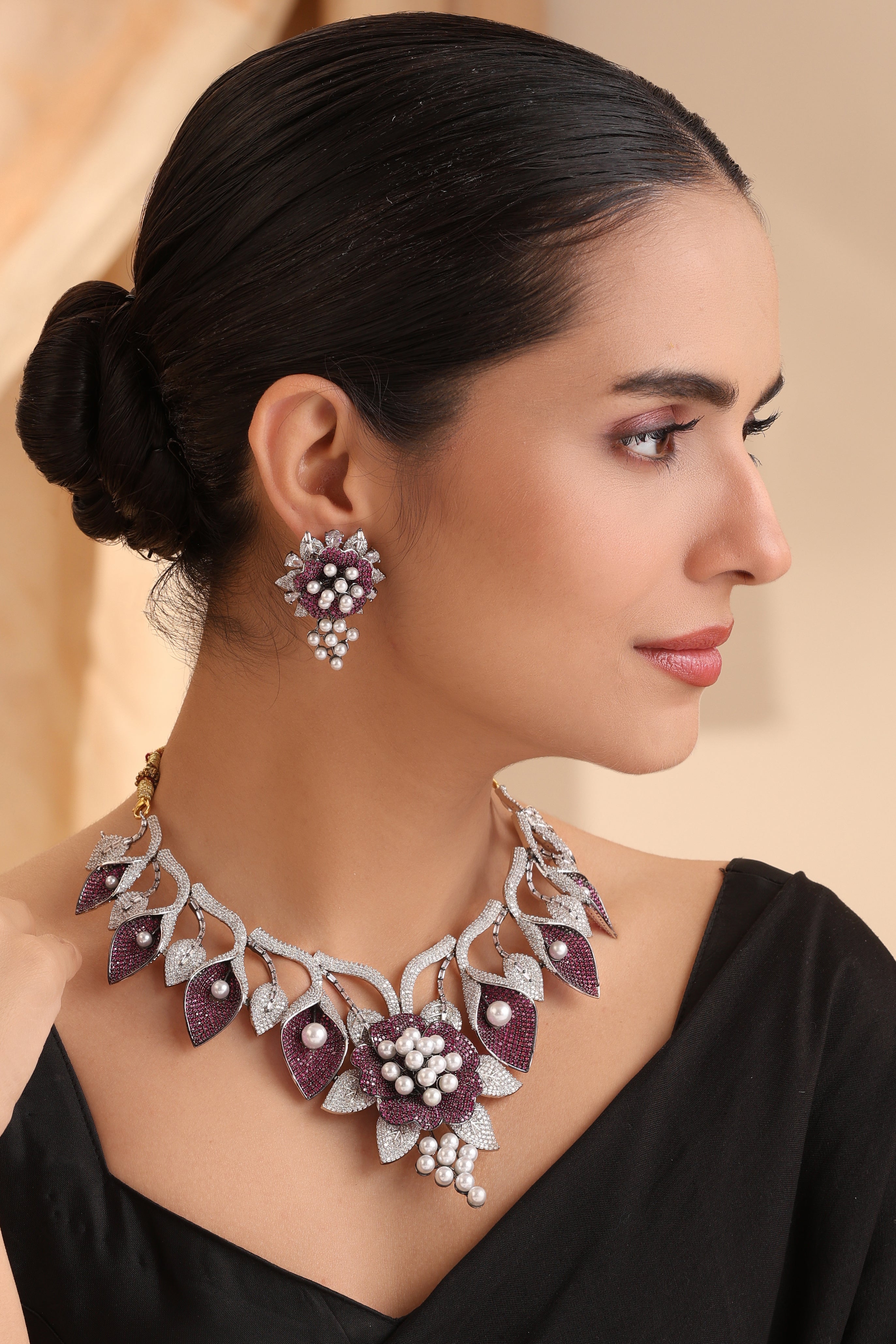 Close-up of Imperial Amethyst Pearl Blossom Necklace Set featuring pave CZ leaves, amethyst stones, and pearl accents in a luxury floral design