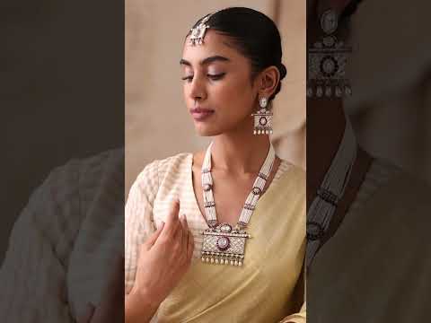 Model wearing uncut moissanite long pearl necklace set with ruby detailing and matching earrings