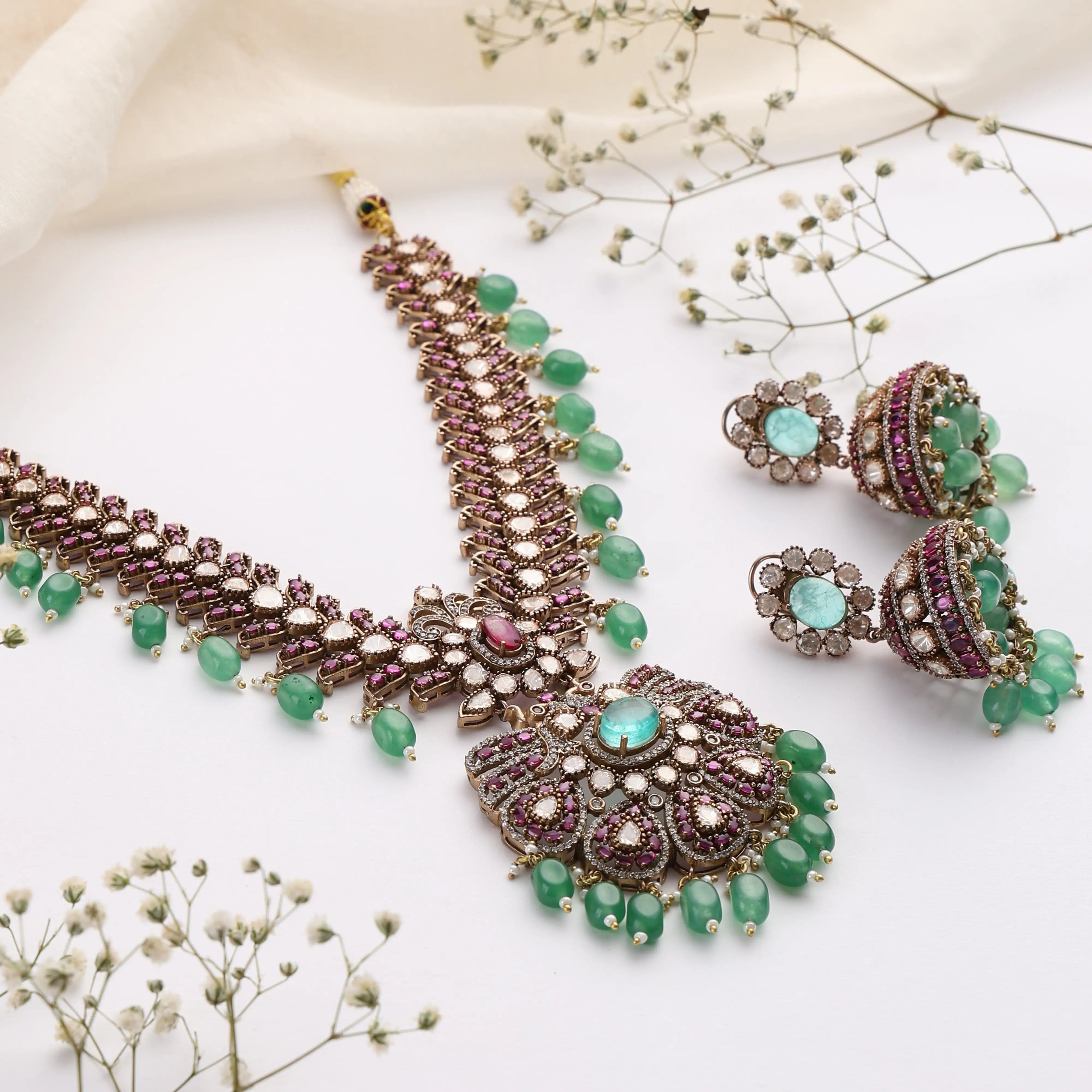 Regal Emerald Ruby Kundan Necklace with Jhumka Earrings in Antique Gold Finish